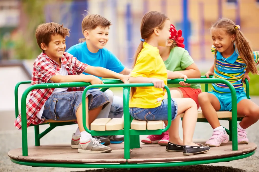kids playing laughing with carousel