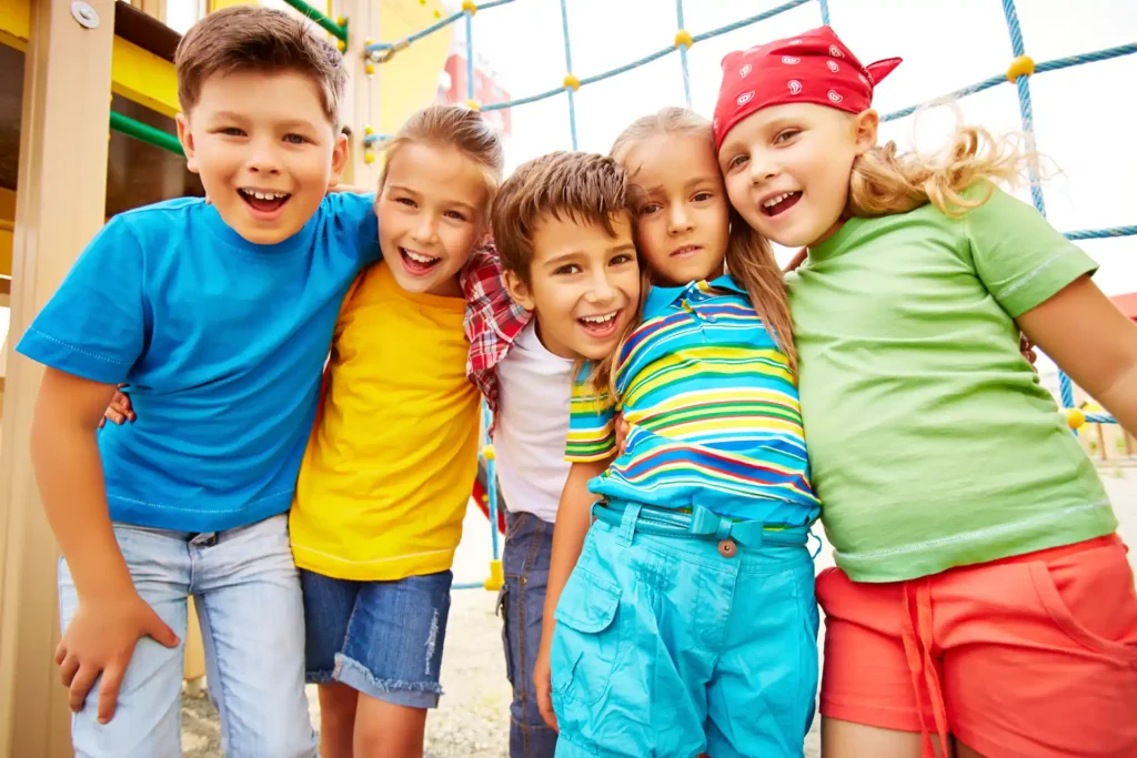 smiling friends hugging playground